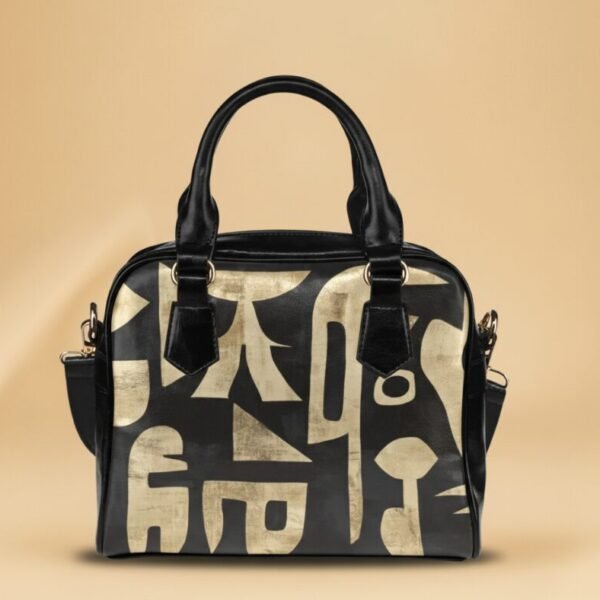 Sac à main noir Maïa Muto L'Amana Vision avec grandes formes abstraites dorées sculpturales.